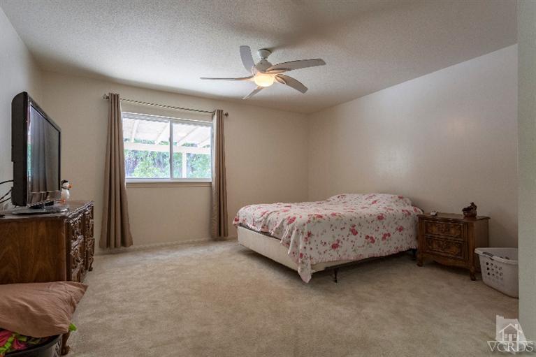 4724 Barnard Street Simi Valley, CA 93063 - Photo 17 of 30 a bedroom with a bed and a flat tv screen on the dresser