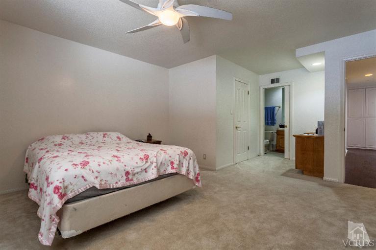 4724 Barnard Street Simi Valley, CA 93063 - Photo 18 of 30 a bedroom with a bed and a chandelier
