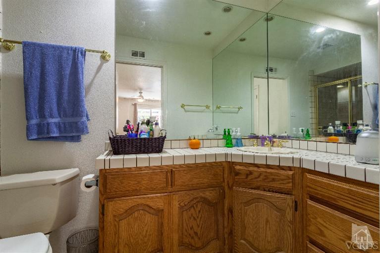 4724 Barnard Street Simi Valley, CA 93063 - Photo 19 of 30 a living room with a sink and a mirror