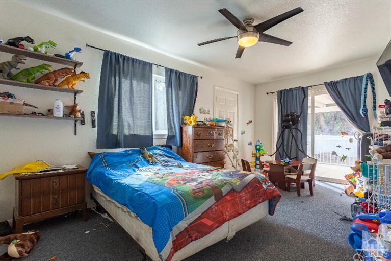 4724 Barnard Street Simi Valley, CA 93063 - Photo 21 of 30 a bedroom with a bed and a chandelier