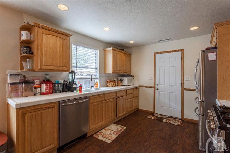 4724 Barnard Street Simi Valley, CA 93063 - Photo 8 of 30 a kitchen with sink cabinets and window