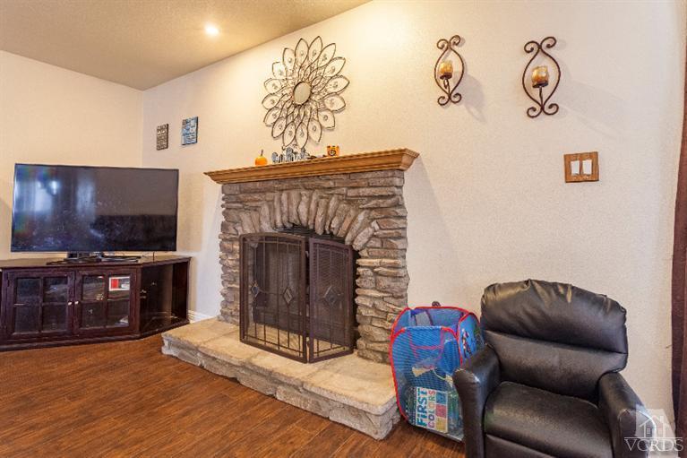 4724 Barnard Street Simi Valley, CA 93063 - Photo 9 of 30 a living room with furniture a flat screen tv and a fireplace