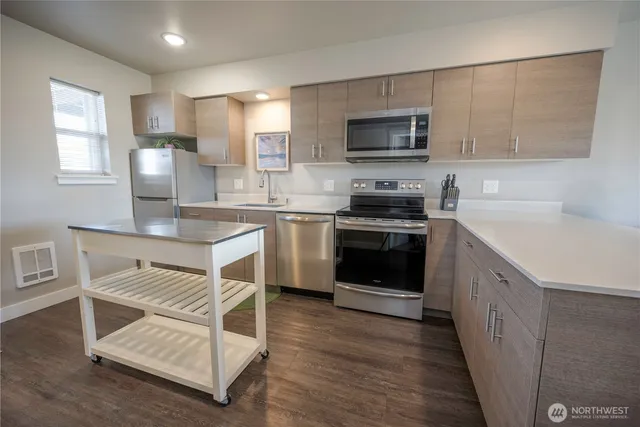 a kitchen with a stove a sink and a microwave
