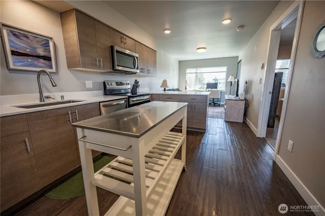 a kitchen with a sink appliances and cabinets