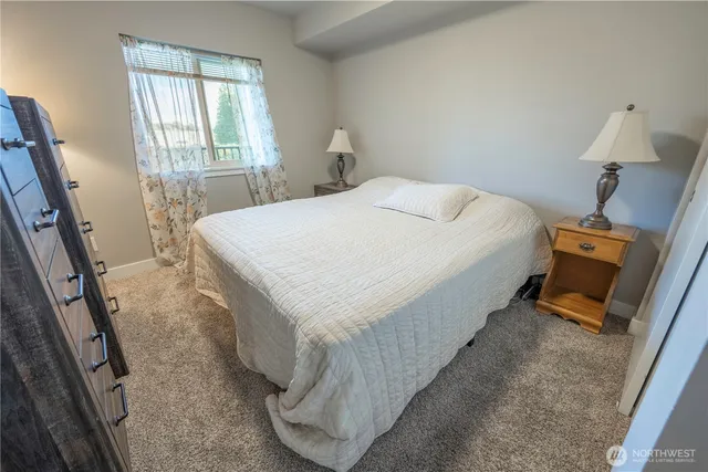 a bed sitting in a bedroom next to a window