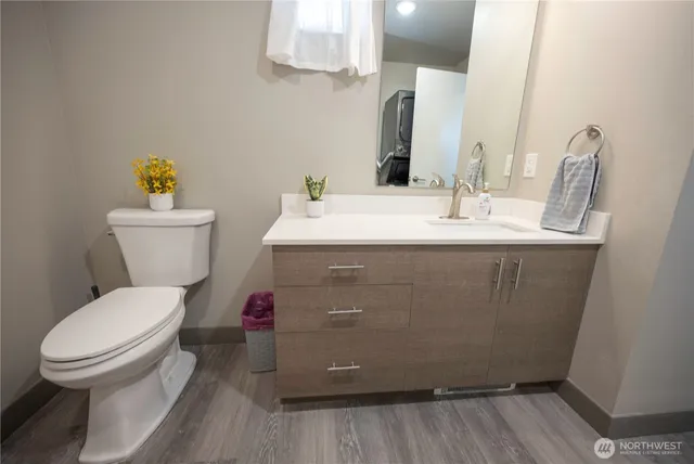 a bathroom with a sink toilet and a mirror
