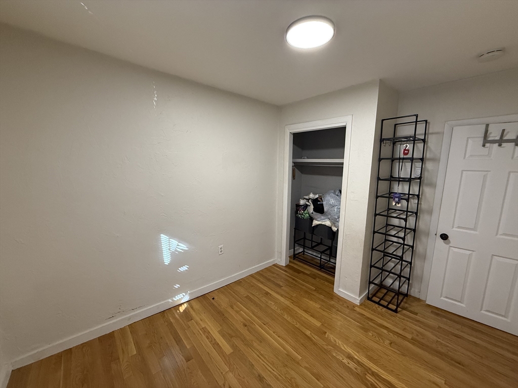 181 Bowen Street, Unit 1 Boston, MA 02127 - Photo 5 of 8 wooden floor in an empty room