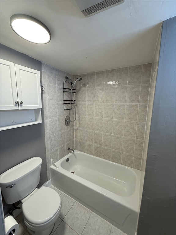 181 Bowen Street, Unit 1 Boston, MA 02127 - Photo 6 of 8 a white toilet sitting next to a bath tub