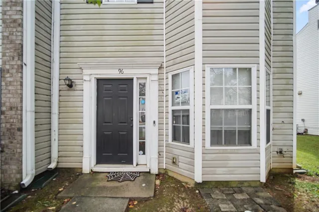 a backyard of a house with plants and outdoor seating