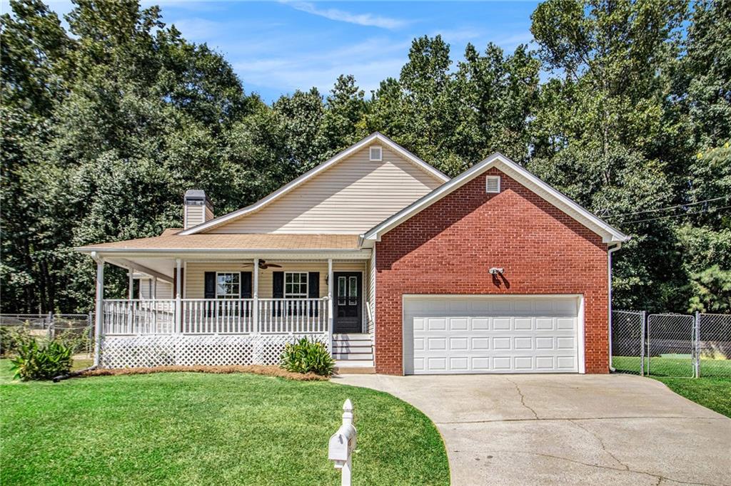 256 Hunt Club Circle Temple, GA 30179 - Photo 1 of 1 a front view of a house with a yard and garage