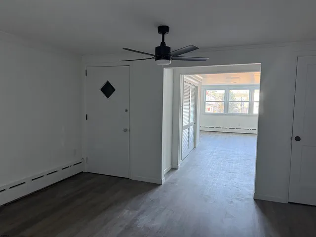 wooden floor in an empty room with a window