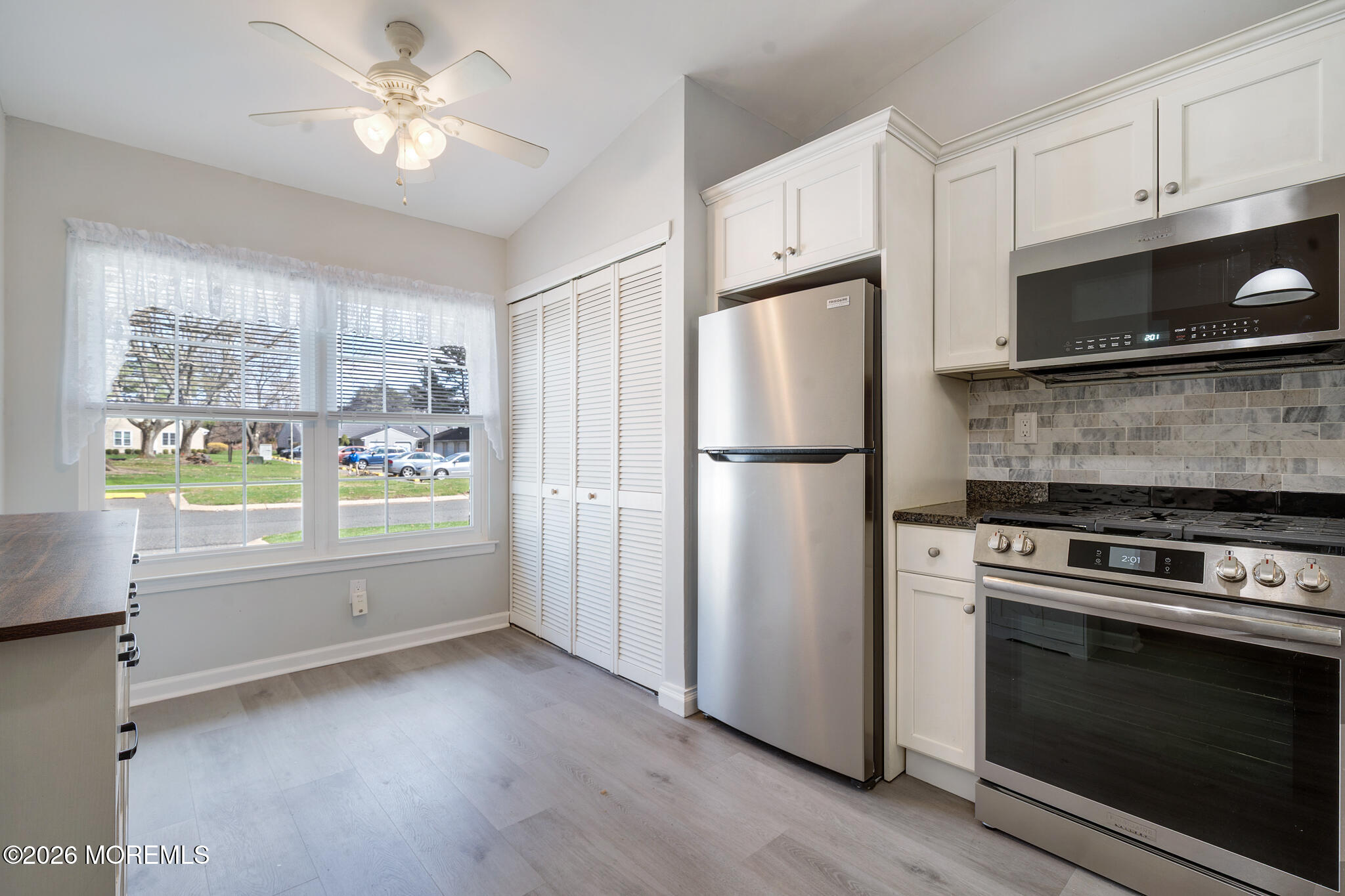 56 Privet Place Red Bank, NJ 07701 - Photo 4 of 19 a kitchen with stainless steel appliances a stove a refrigerator and a microwave