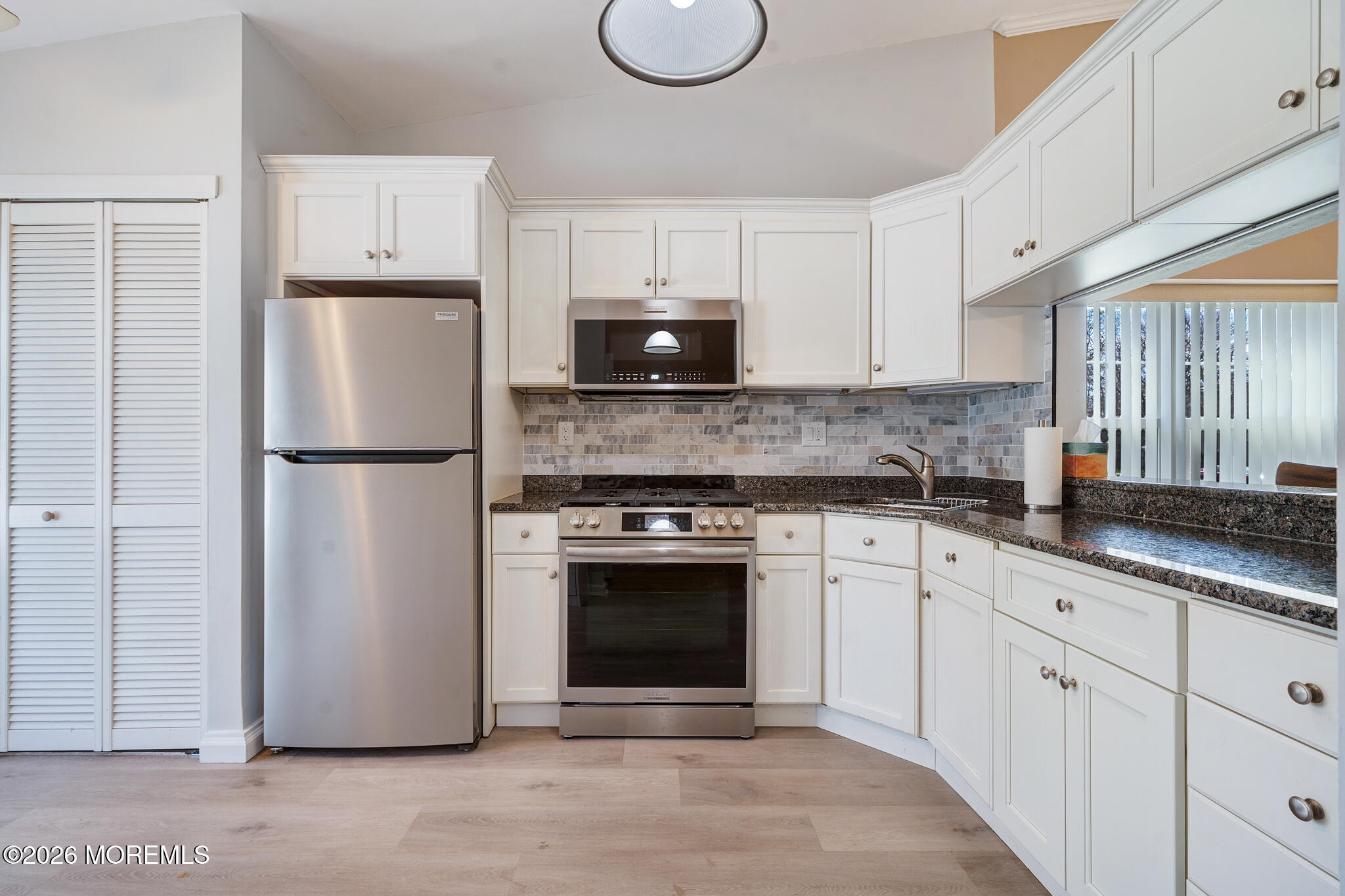 56 Privet Place Red Bank, NJ 07701 - Photo 6 of 19 a kitchen with granite countertop a refrigerator sink and cabinets