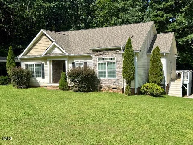 a view of house with yard and green space