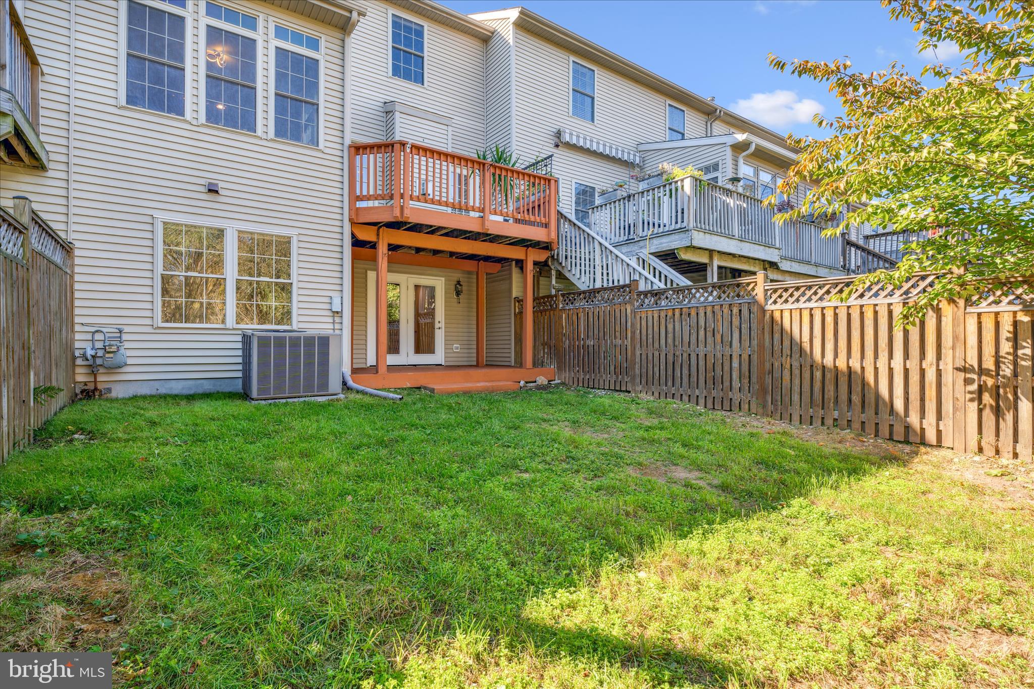 2442 Rippling Brook Road Frederick, MD 21701 - Photo 55 of 85 a view of a house with brick walls and a yard with wooden fence