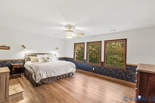 a living room with a fireplace wooden floor and a fireplace