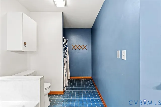 a bathroom with a sink mirror vanity and toilet