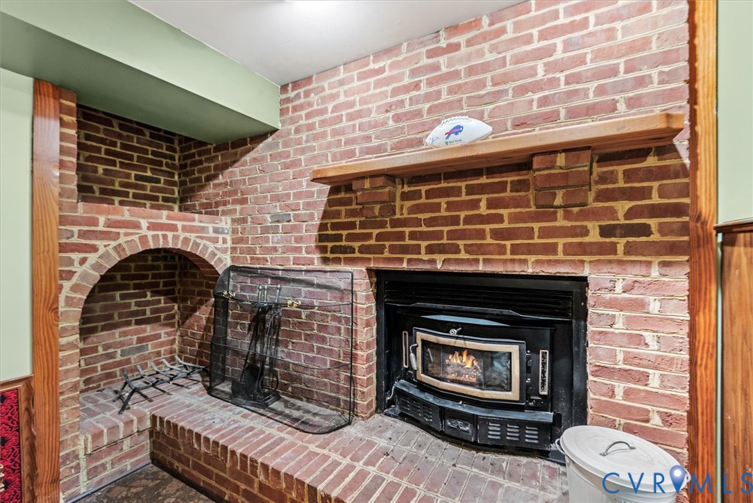 7358 Peppermill Road King George, VA 22485 - Photo 36 of 49 a living room with a fireplace wooden floor and a fireplace