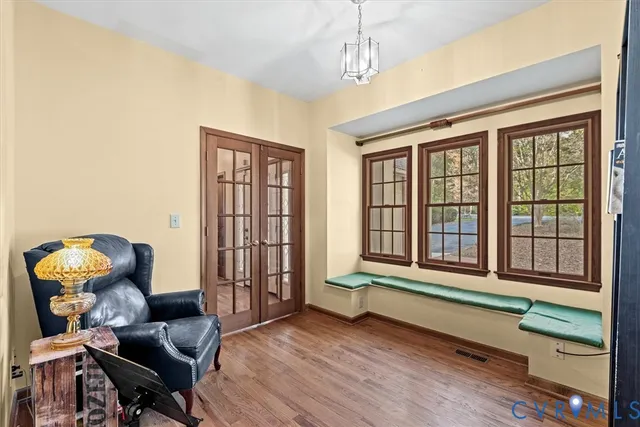 a view of a dining room with furniture window and wooden floor