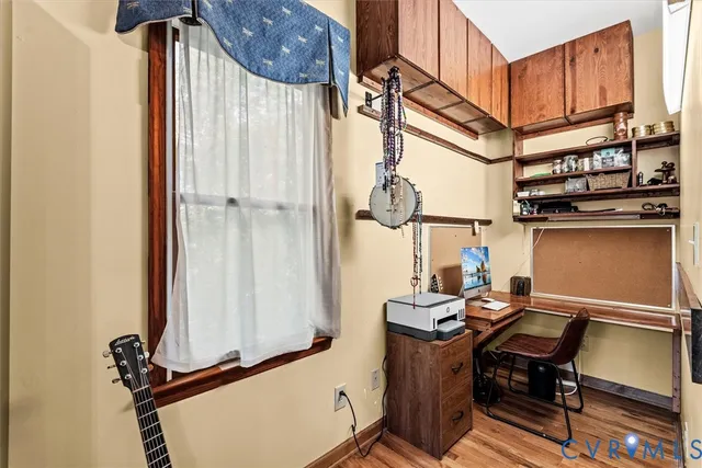 a kitchen with a sink window and cabinets