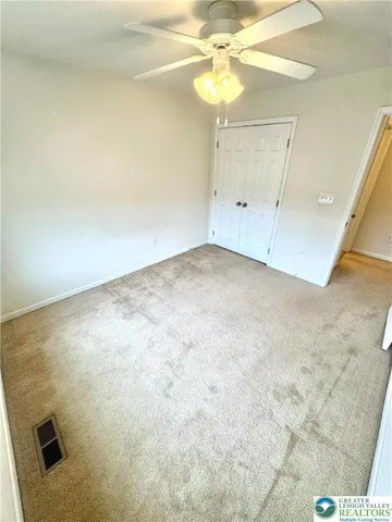 en empty room with an entryway and chandelier