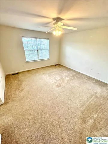 an empty room with a empty space and windows