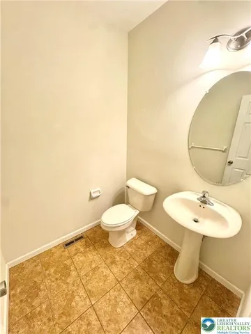 a bathroom with a sink a toilet and mirror