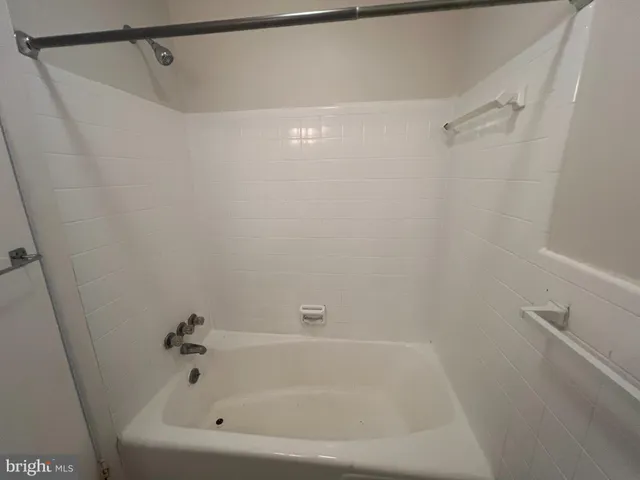 a bathroom with a shower and a bath tub