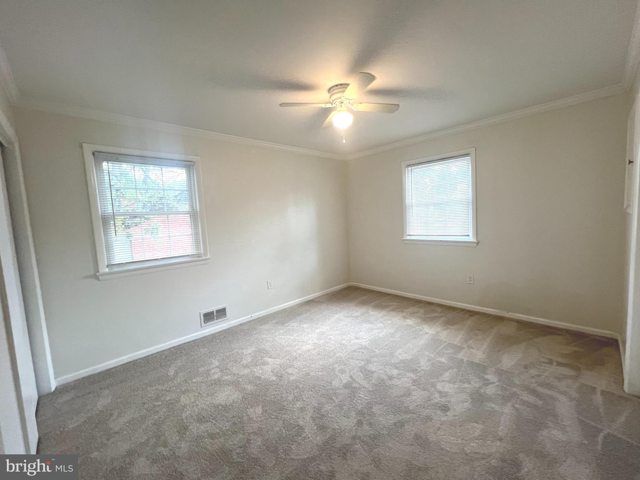 4517 North Carlin Springs Road Arlington, VA 22203 - Photo 7 of 21 an empty room with windows and fan