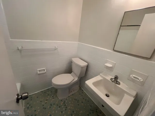 a bathroom with a sink toilet and a mirror
