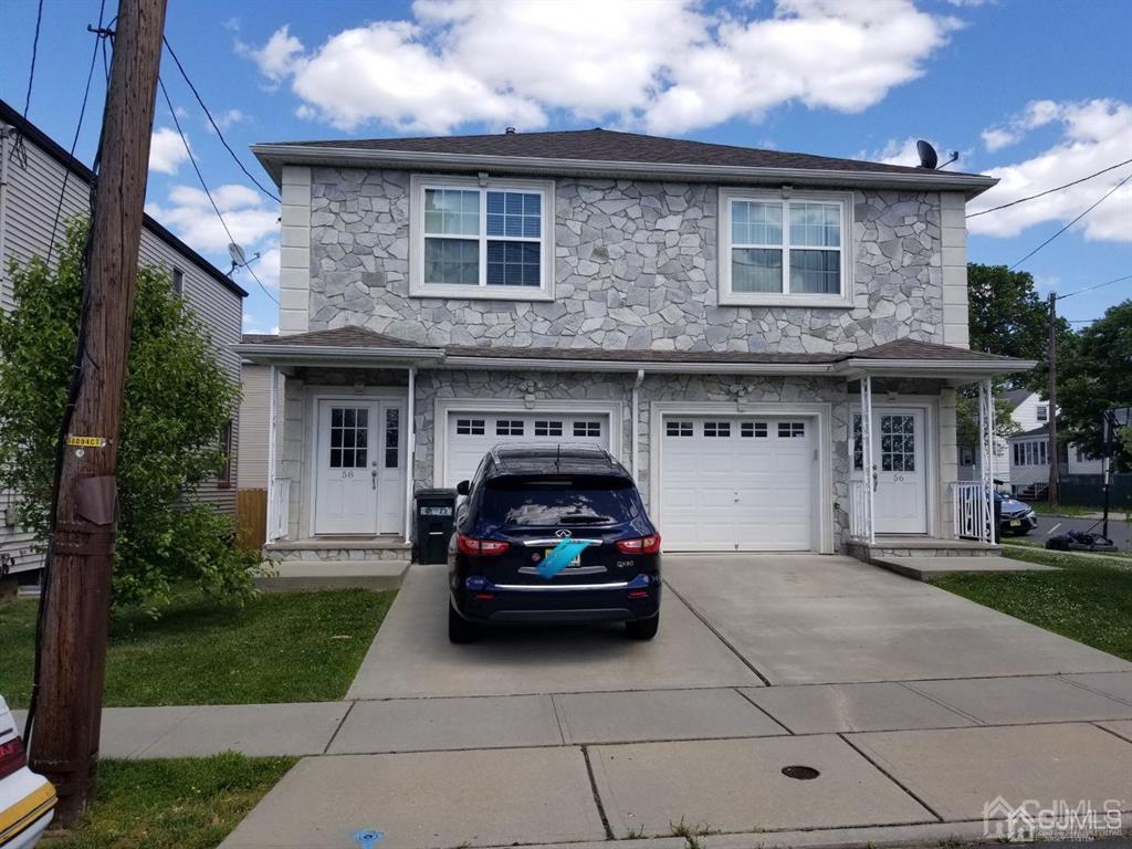 a car parked in front of a brick house