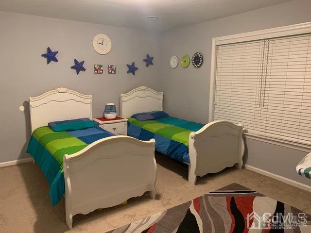 a bedroom with a bed and wall painting