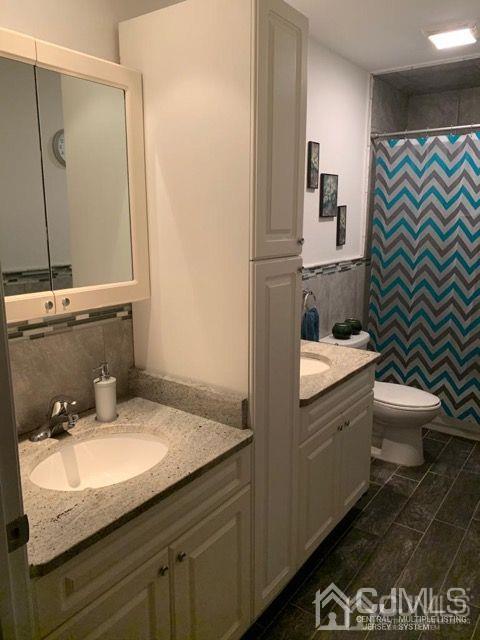 58 Christopher Street Carteret, NJ 07008 - Photo 17 of 20 a bathroom with a granite countertop sink toilet and shower