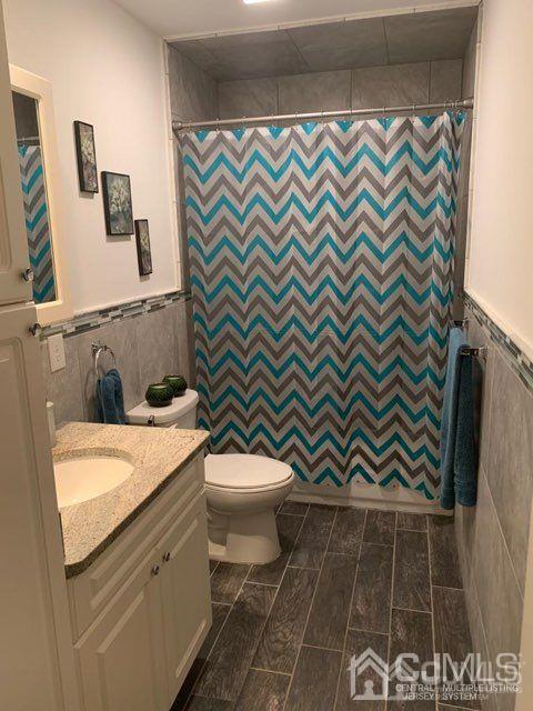 58 Christopher Street Carteret, NJ 07008 - Photo 18 of 20 a bathroom with a sink a toilet and a shower