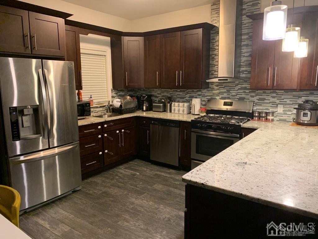 58 Christopher Street Carteret, NJ 07008 - Photo 7 of 20 a kitchen with stainless steel appliances granite countertop a sink stove and refrigerator