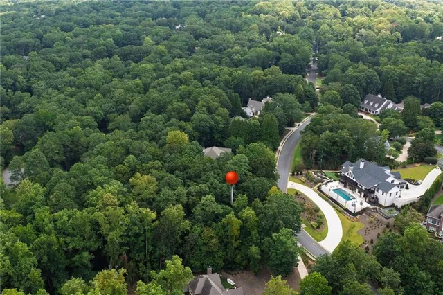 an aerial view of a house with a yard and outdoor seating