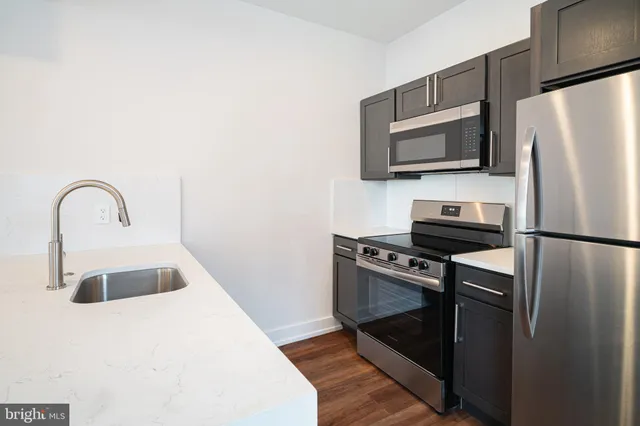 a kitchen with a refrigerator and a sink