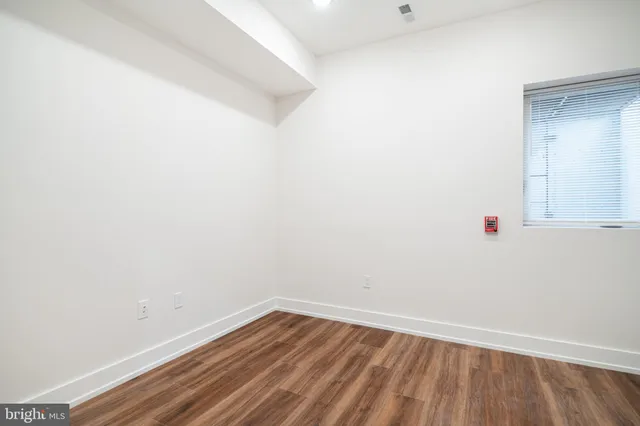 a room with wooden floor and cabinet