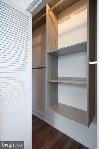 a view of walk in closet with empty racks