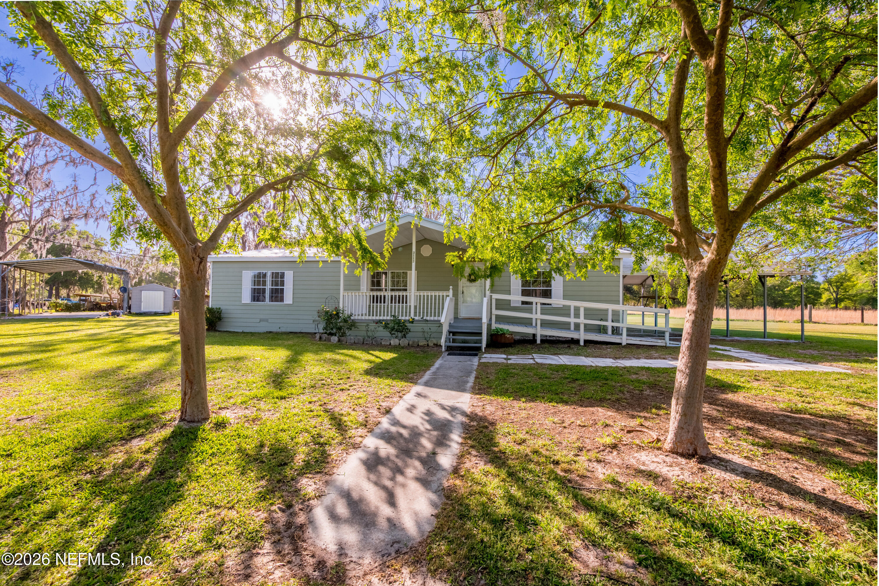 3112 Southeast 120th Street Starke, FL 32091 - Photo 2 of 30 a view of a house with swimming pool next to a big yard