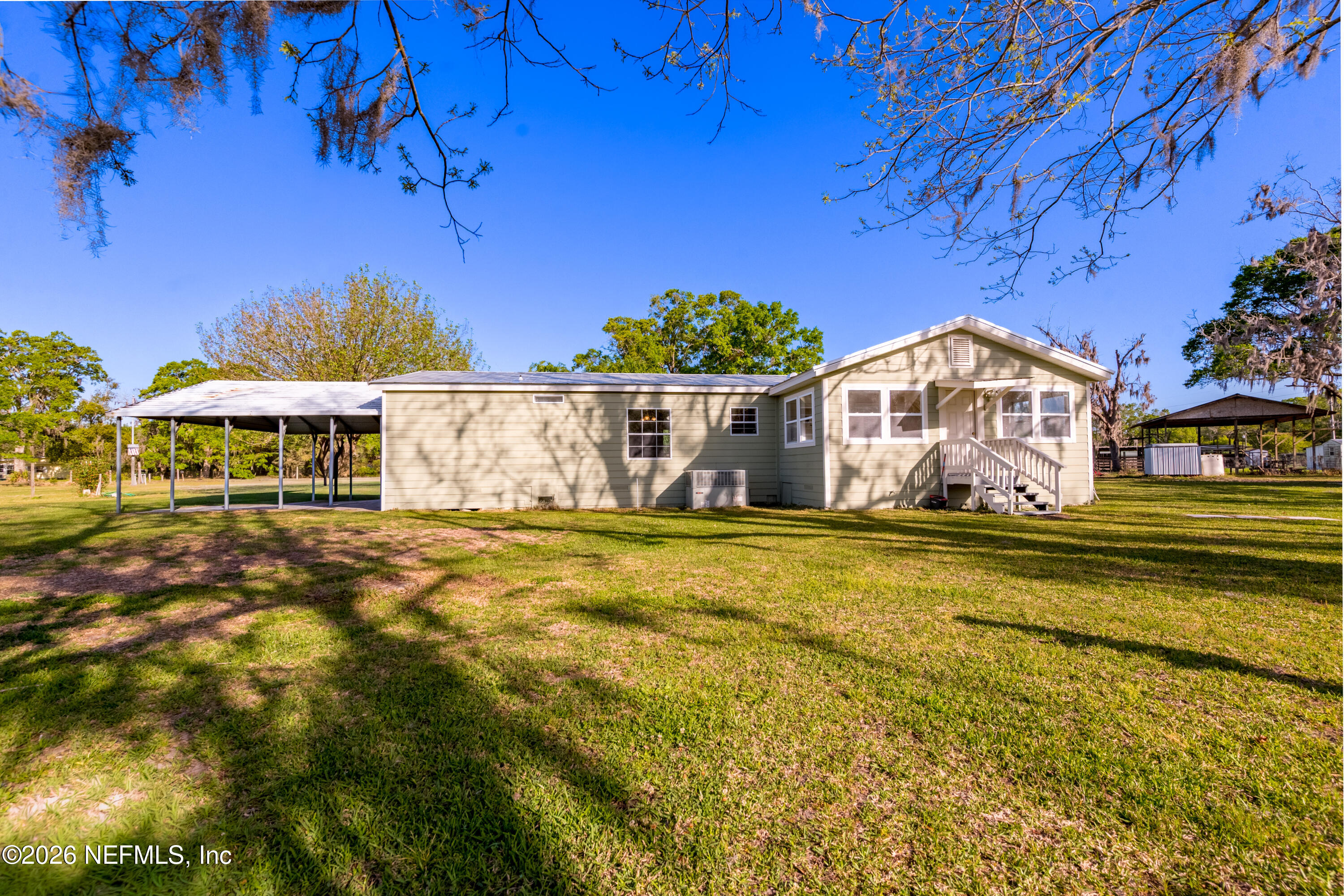 3112 Southeast 120th Street Starke, FL 32091 - Photo 26 of 30 a front view of a house with a garden