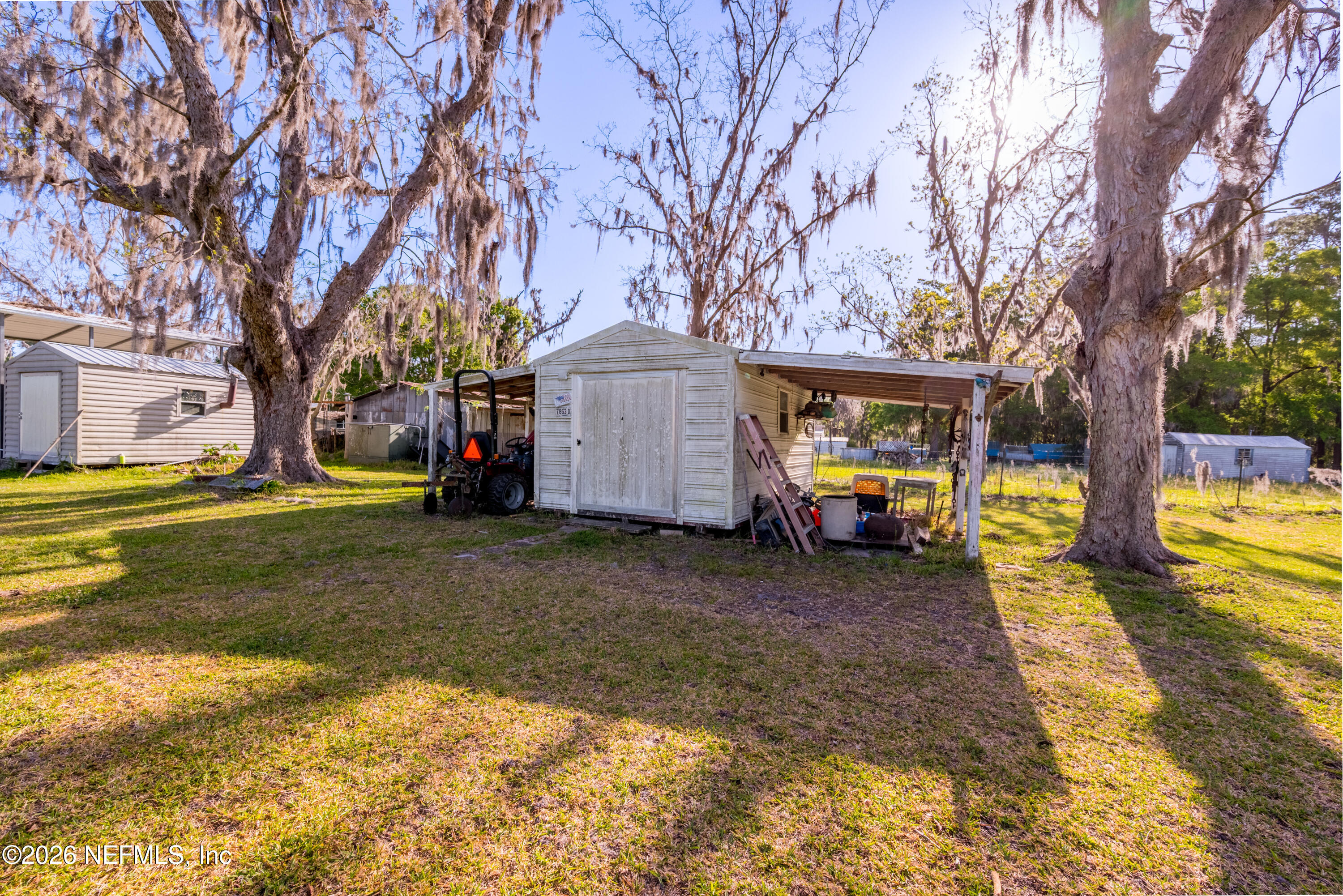 3112 Southeast 120th Street Starke, FL 32091 - Photo 29 of 30 a view of a yard with a house and a large tree