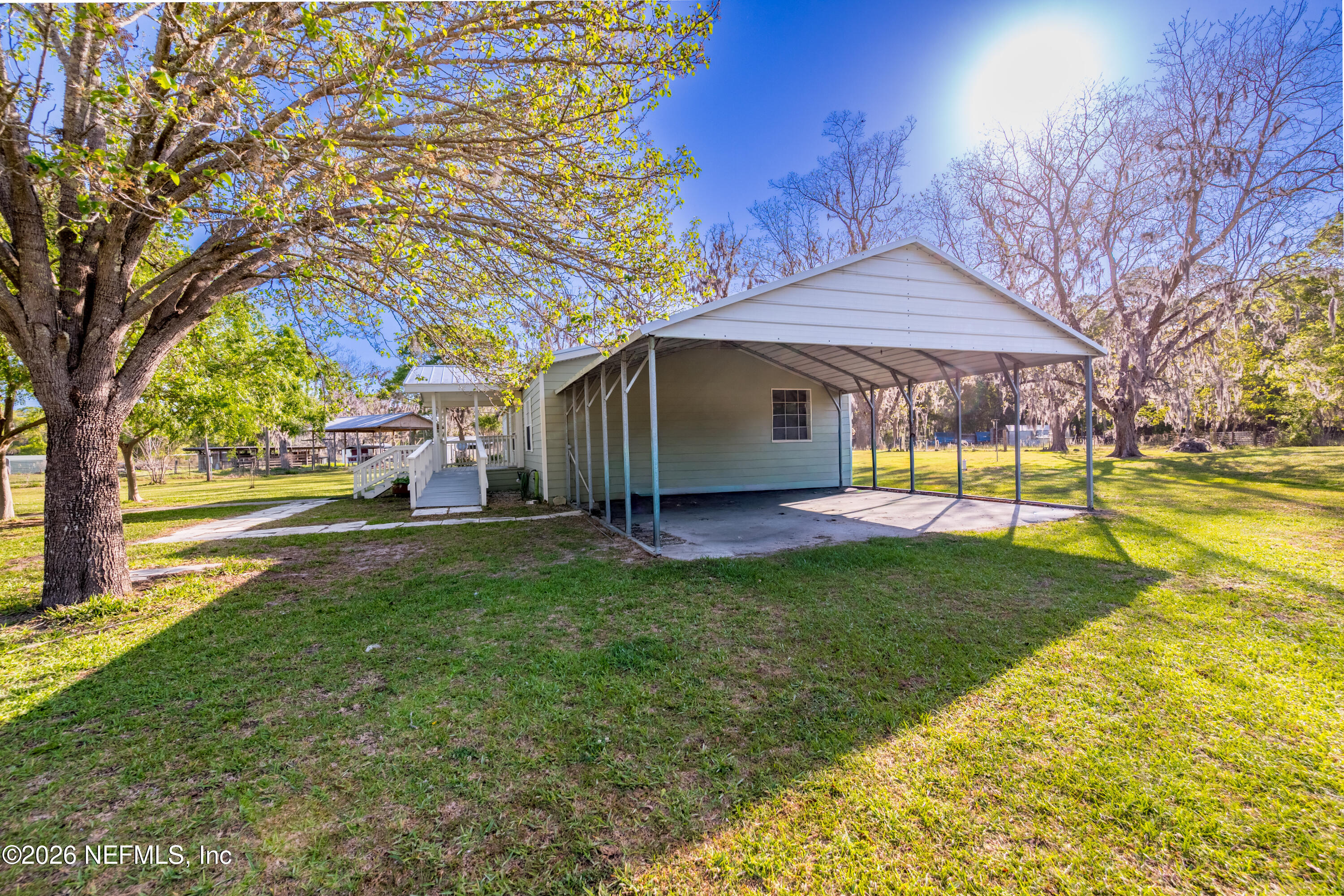 3112 Southeast 120th Street Starke, FL 32091 - Photo 4 of 30 a view of a house with backyard and a tree