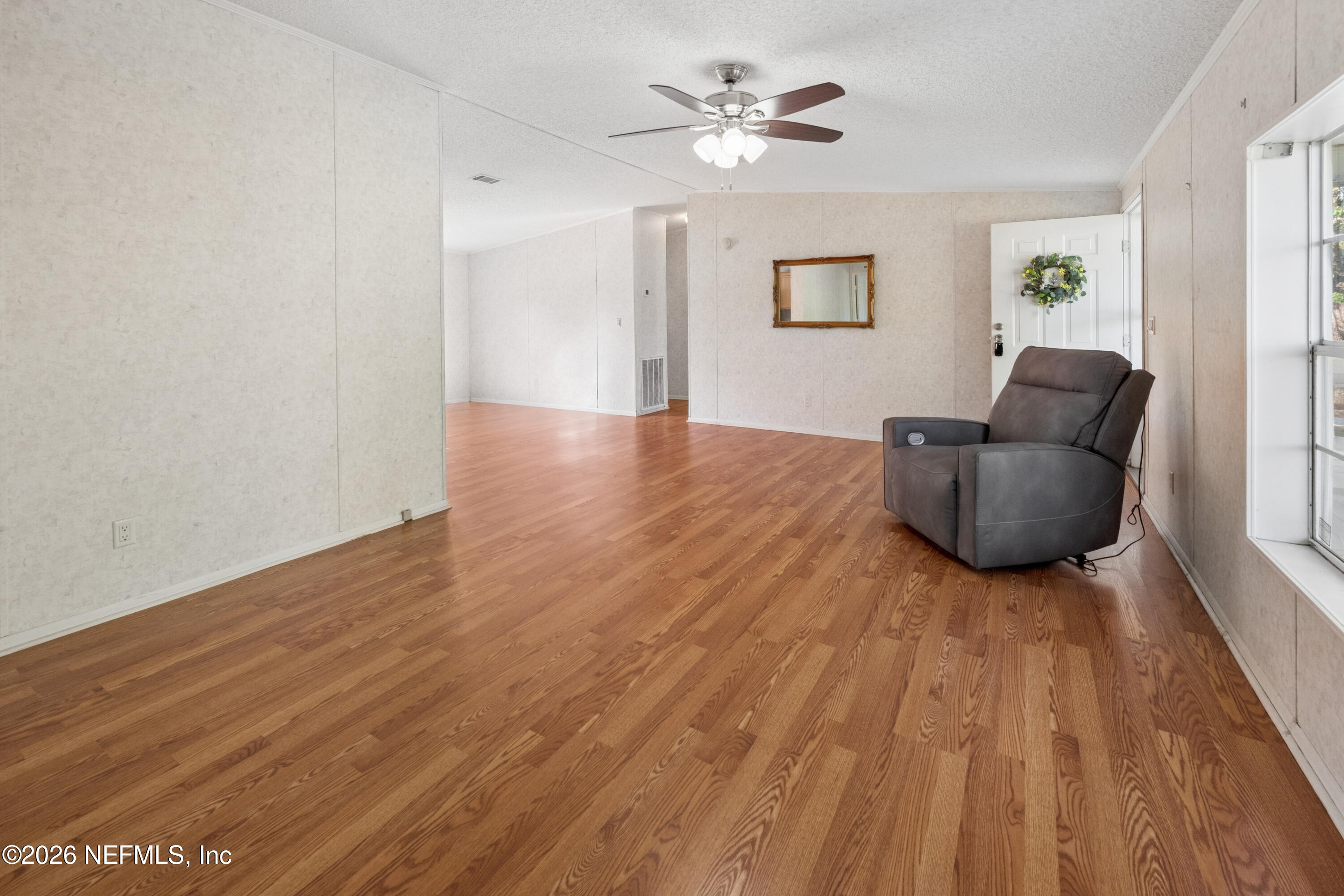 3112 Southeast 120th Street Starke, FL 32091 - Photo 6 of 30 a living room with furniture and a wooden floor