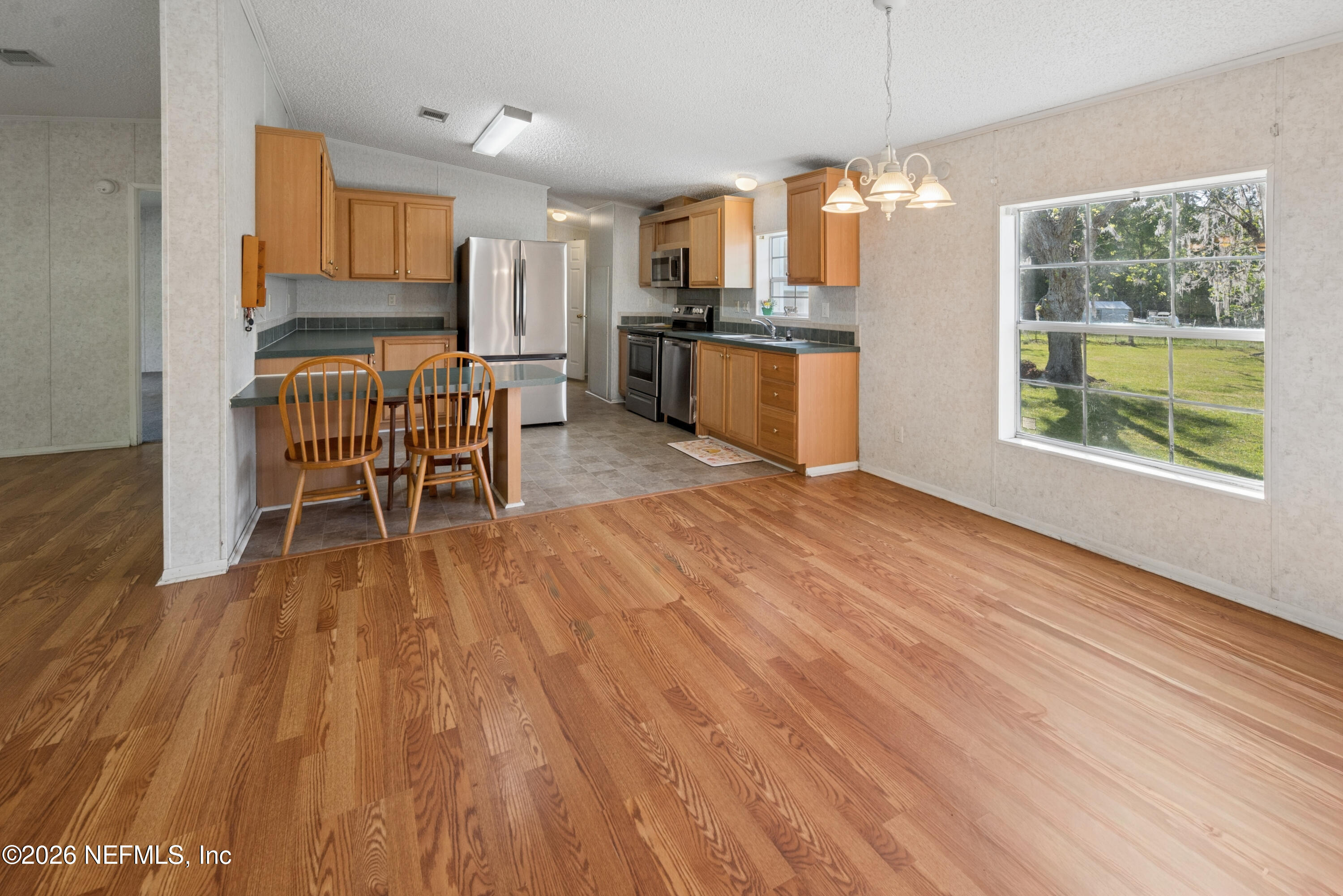 3112 Southeast 120th Street Starke, FL 32091 - Photo 8 of 30 a view of a kitchen with furniture window wooden floor and outdoor space