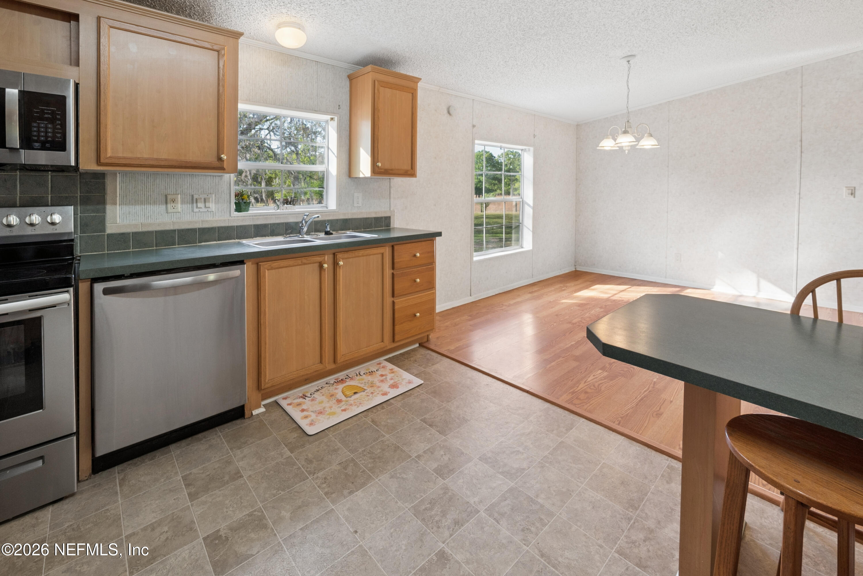 3112 Southeast 120th Street Starke, FL 32091 - Photo 10 of 30 a kitchen with granite countertop a sink a stove top oven appliances and cabinets
