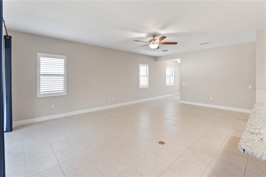 13017 Steinhatchee Loop Venice, FL 34293 - Photo 19 of 98 an empty room with windows and ceiling fan