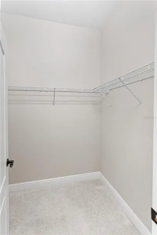 an aerial view of a tennis ground with a mountain in the background