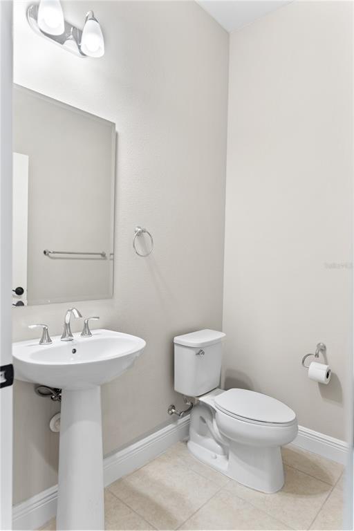 13017 Steinhatchee Loop Venice, FL 34293 - Photo 39 of 98 a bathroom with a sink a toilet and a mirror