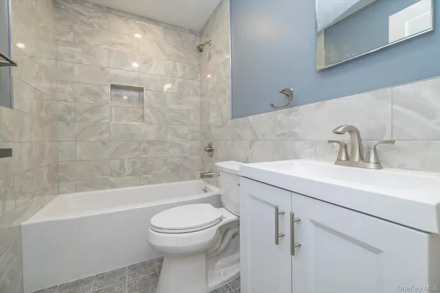 a bathroom with a sink a toilet and a bathtub